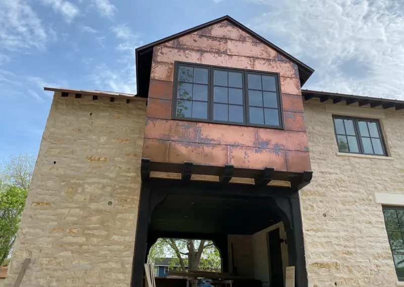 Copper metal panel facade on a stone building for Skylight Installation in Locust Grove